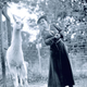 Mrs Harriet Franklin poses with a llama at the zoo (1912).